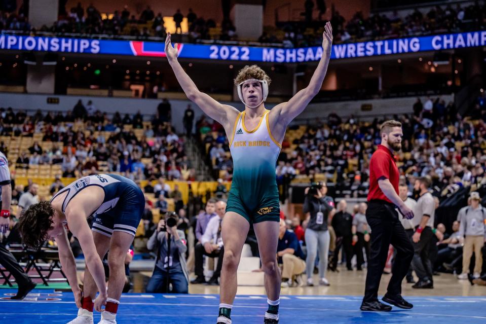 Rock Bridge junior Carter McCallister (138) raises his arms in celebration after winning his second straight state title last season at Mizzou Arena.
