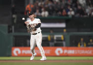San Francisco Giants third baseman David Villar throws to first base for the out on Milwaukee Brewers' Rowdy Tellez during the seventh inning of a baseball game in San Francisco, Thursday, July 14, 2022. (AP Photo/Godofredo A. Vásquez)