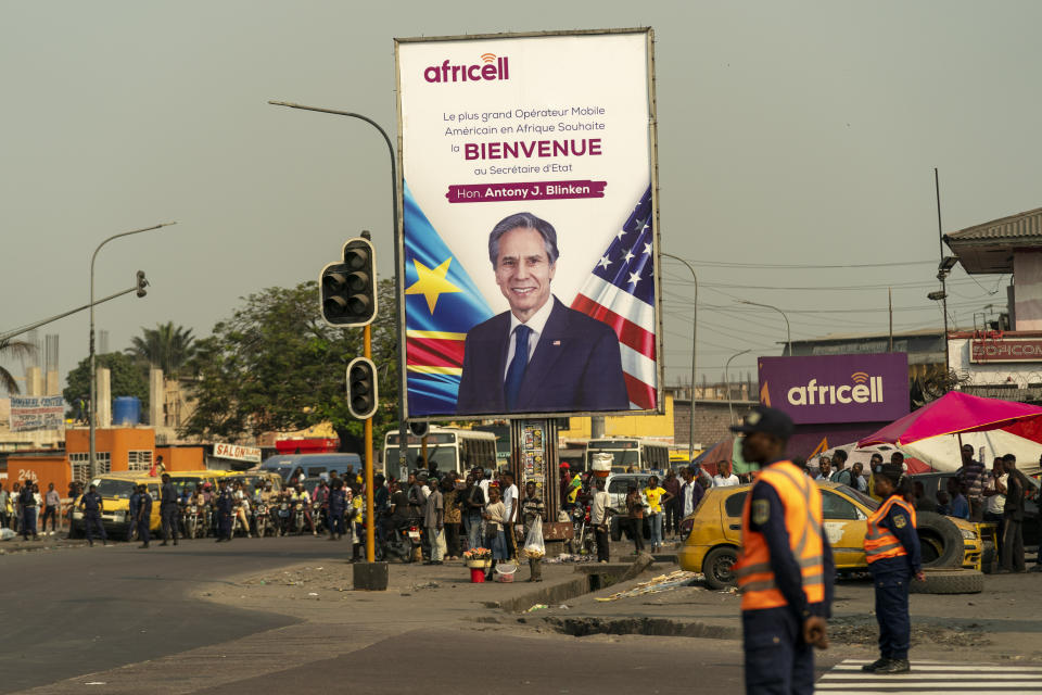 A poster of Secretary of State Antony Blinken is visible as his motorcade moves through Kinshasa, Congo, Tuesday, Aug. 9, 2022. Blinken is on a ten day trip to Cambodia, Philippines, South Africa, Congo, and Rwanda. (AP Photo/Andrew Harnik, Pool)