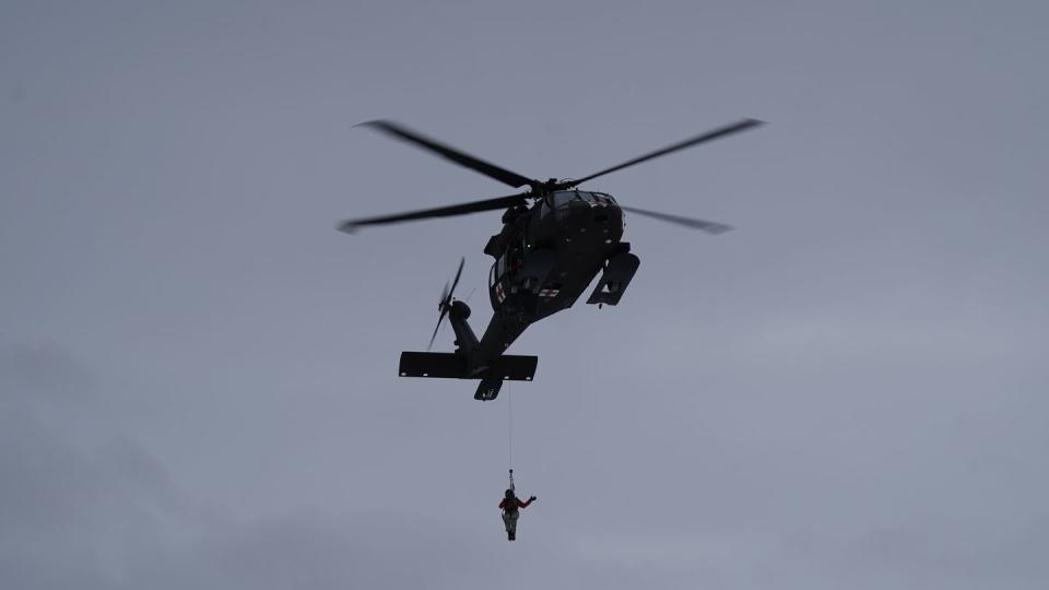 Alaska Army National Guard Spc. Matthew Tucker is lowered from an Alaska Army National Guard HH-60M Black Hawk helicopter at Camp Mad Bull on Joint Base Elmendorf-Richardson, Alaska, Jan. 10, 2023. (Dana Rosso/Army)