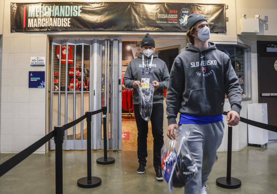 Players from the Slovakian team purchase souvenirs after the remainder of IIHF World Junior Hockey Championship was cancelled due to -cv1- on Wednesday, Dec. 29, 2021, in Red Deer, Alberta. (Jeff McIntosh/The Canadian Press via AP)