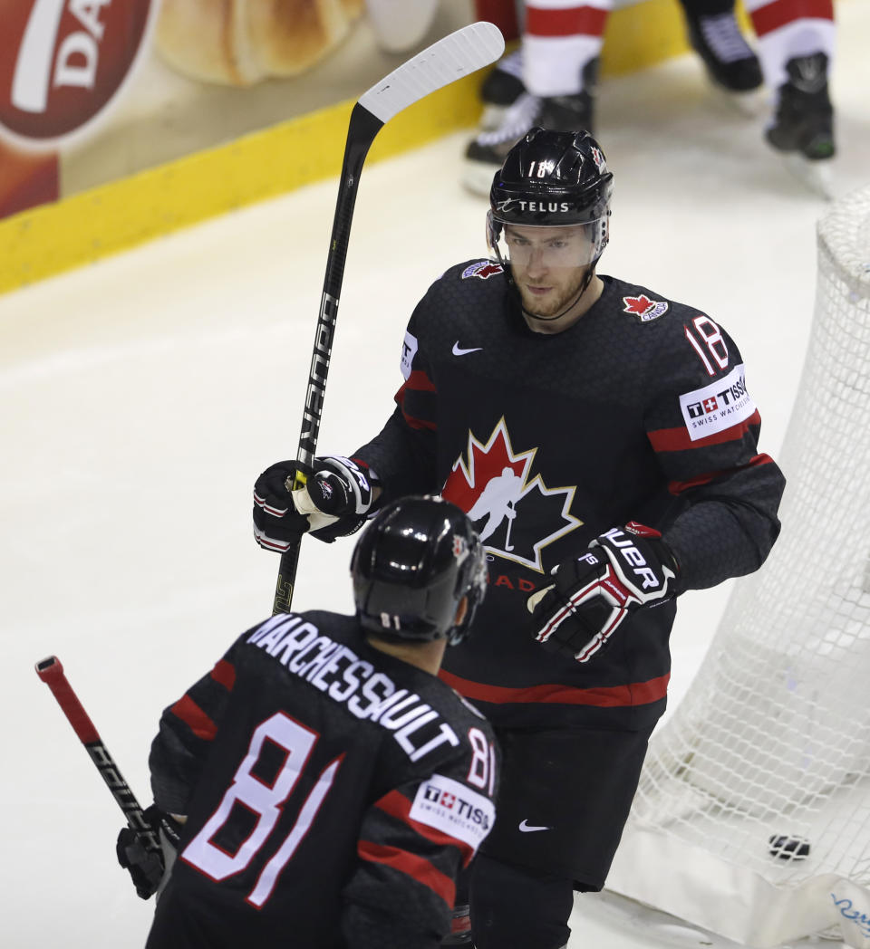 Canada's Pierre-Luc Dubois, right, celebrates with Canada's Jonathan Marchessault, left, after scoring his sides first goal during the Ice Hockey World Championships group A match between Canada and Denmark at the Steel Arena in Kosice, Slovakia, Monday, May 20, 2019. (AP Photo/Petr David Josek)