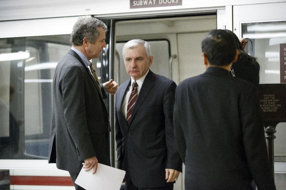 Sen. Jack Reed, D-R.I., right, and Sen. Sherrod Brown, D-Ohio, left, confer before a procedural vote in the Senate on a bill that would extend unemployment benefits, at the Capitol in Washington, Monday, Jan. 6, 2014. Benefits expired for many long-term unemployed Americans on Dec. 28 after lawmakers did not extend the program as part of a bipartisan budget agreement. Sen. Jack Reed, D-R.I., is leading the effort to reauthorize the benefits for three months nationwide, but Republicans are balking however have balked at the proposed extension without offsets for the $6.5 billion that it will cost. (AP Photo/J. Scott Applewhite)