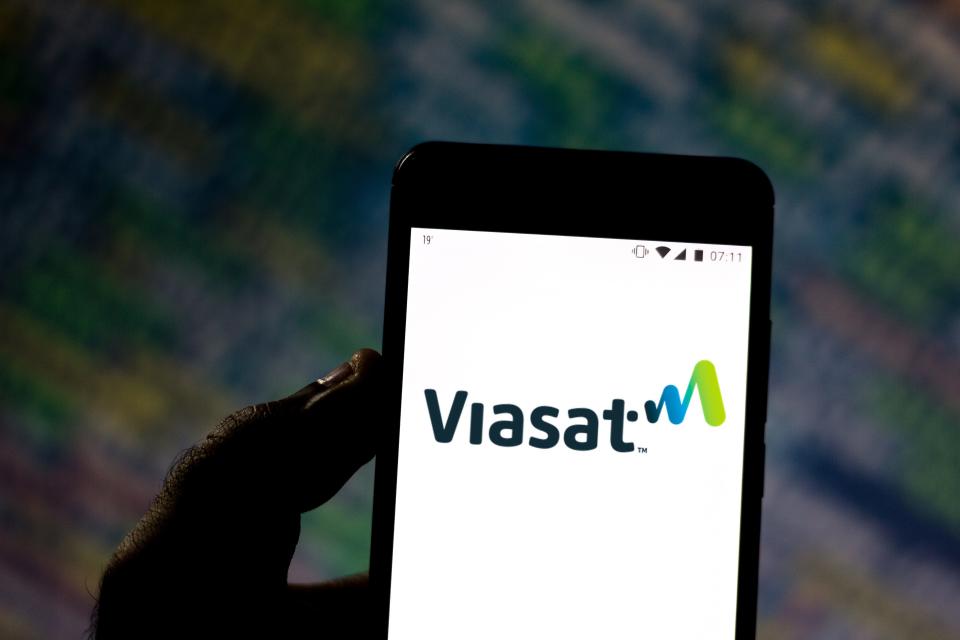 In this photo illustration the ViaSat logo is displayed on a smartphone.