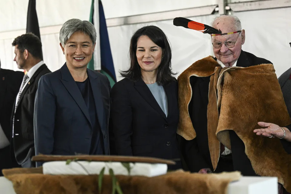 Germany's Foreign Minister Annalena Baerbock, center, poses with Lewis O'Brien, the oldest living Kaurna man, and Australian Foreign Minister Penny Wong, left, in Adelaide, Friday, May 3, 2024, during a ceremony to mark the return of four significant cultural heritage items to the Kaurna people from the collection of the Grassi Museum in Leipzig. (Michael Errey/Pool Photo via AP)