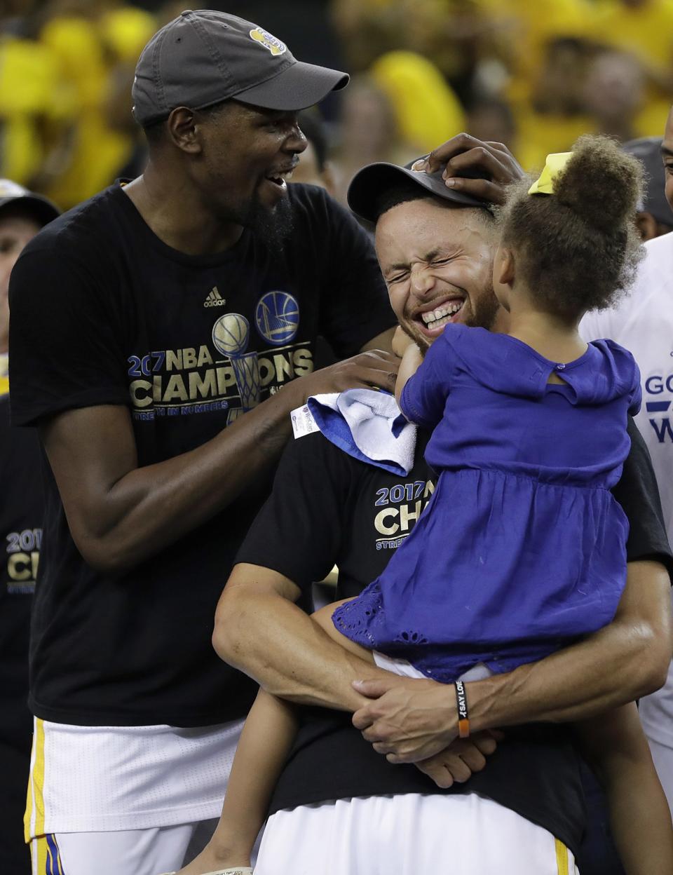 <p>Golden State Warriors guard Stephen Curry, center, holds his daughter Riley as they celebrate with forward Kevin Durant, left, after Game 5 of basketball’s NBA Finals against the Cleveland Cavaliers in Oakland, Calif., Monday, June 12, 2017. The Warriors won 129-120 to win the NBA championship. (AP Photo/Marcio Jose Sanchez) </p>