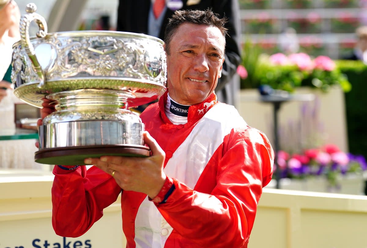 Jockey Frankie Dettori celebrates with the trophy after winning the Coronation Stakes with horse Inspiral during day four of Royal Ascot (PA)