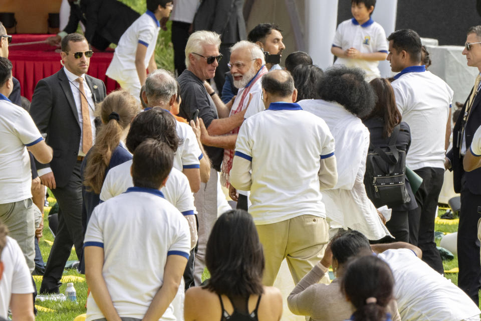 India Prime Minister Narendra Modi, center, embraces with actor Richard Gere, left, during the International Yoga day event at United Nations headquarters in New York on Wednesday, June 21, 2023. Modi has joined diplomats and dignitaries at the United Nations for a morning session of yoga, praising it as “truly universal” and “a way of life.” Modi kicked off the public portion of his U.S. visit at an event honoring the International Day of Yoga. (AP Photo/Jeenah Moon)