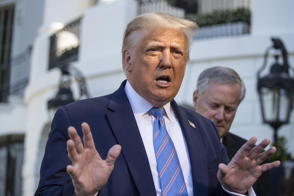 President Donald Trump speaks with reporters as he walks to Marine One on the South Lawn of the White House, Wednesday, July 29, 2020, in Washington. Trump is en route to Texas. (AP Photo/Alex Brandon)