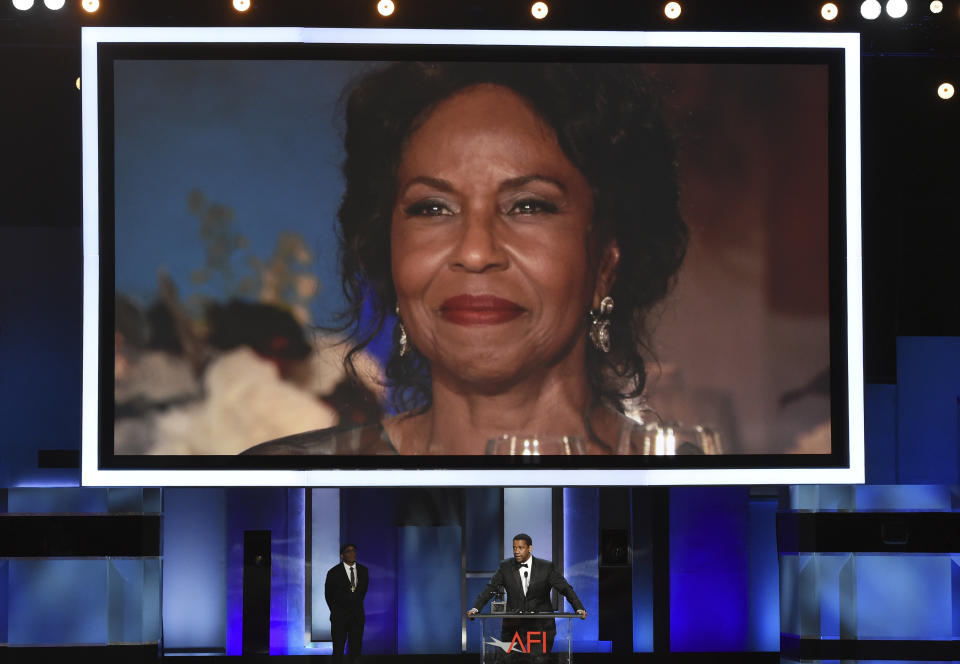 FILE - In this June 6, 2019, file photo, Pauletta Washington, wife of actor Denzel Washington, is seen on a video monitor as her husband accepts the 47th AFI Life Achievement Award during a ceremony in Los Angeles. The award-winning actor, director, and producer is the face of some of the most well-known films of the last few decades, including “Fences,” “Man on Fire,” “Malcolm X,” and “The Book of Eli.” (Photo by Chris Pizzello/Invision/AP, File)