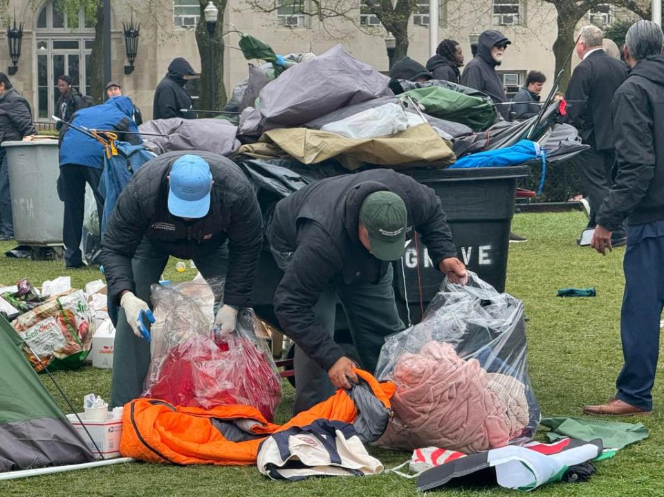 Parts of the encampment are removed by officials. Robert Miller