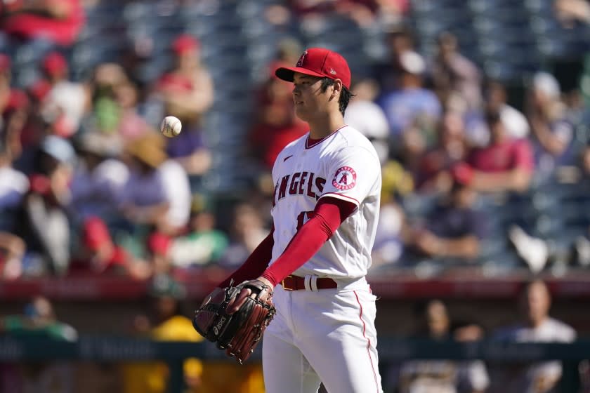 Los Angeles Angels starting pitcher Shohei Ohtani tosses the ball while pitching against the Oakland Athletics.