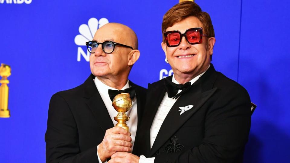 A photo including Bernie Taupin and Elton John