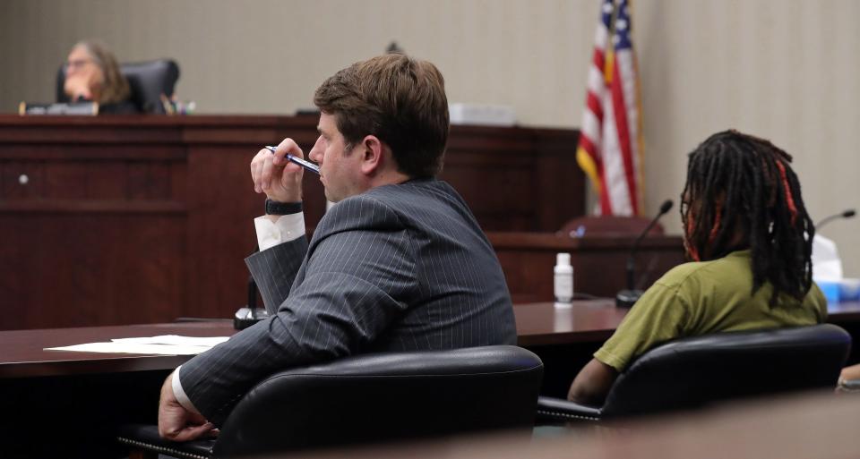 Attorney Brian Ashton listens to an Akron police officer speak during a bindover hearing in Judge Linda Tucci Teodosio's courtroom at Summit County Juvenile Court in Akron.