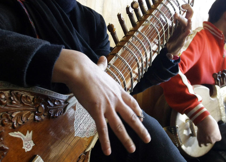 FILE - In this Jan. 7, 2013 file photo, an Afghan girl practices playing the sitar in a class at the Afghan National Institute of Music, ANIM, in Kabul, Afghanistan. A few years after the Taliban were ousted in 2001, and with Afghanistan still in ruins, Ahmad Sarmast left his home in Melborne, Australia where he had sought asylum in the 90s, on a mission: to revive music in the country of his birth. The music school Sarmast founded was a unique experiment in inclusivity for the war-ravaged nation — with orphans and street kids in the student body. (AP Photo/Musadeq Sadeq, File)