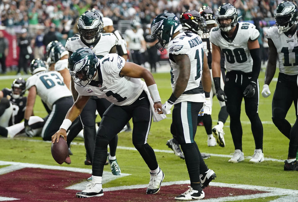 Philadelphia Eagles quarterback Jalen Hurts (1) celebrates after scoring a touchdown against the Arizona Cardinals. (AP Photo/Ross D. Franklin)