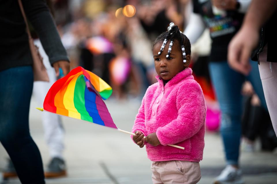 A young parade goer watches as the Knox Pride Parade parades down Gay Street in downtown Knoxville on Friday, Sept. 30, 2022. Knox Pride will continues its annual Pride Fest activities at World's Fair Park through Sunday, Oct. 2, 2022.