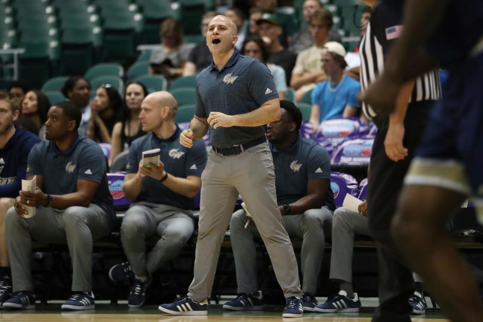 George Washington head coach Chris Caputo is seen on the sidelines as his team takes on Washington State during the first half of an NCAA college basketball game, Thursday, Dec. 22, 2022, in Honolulu.