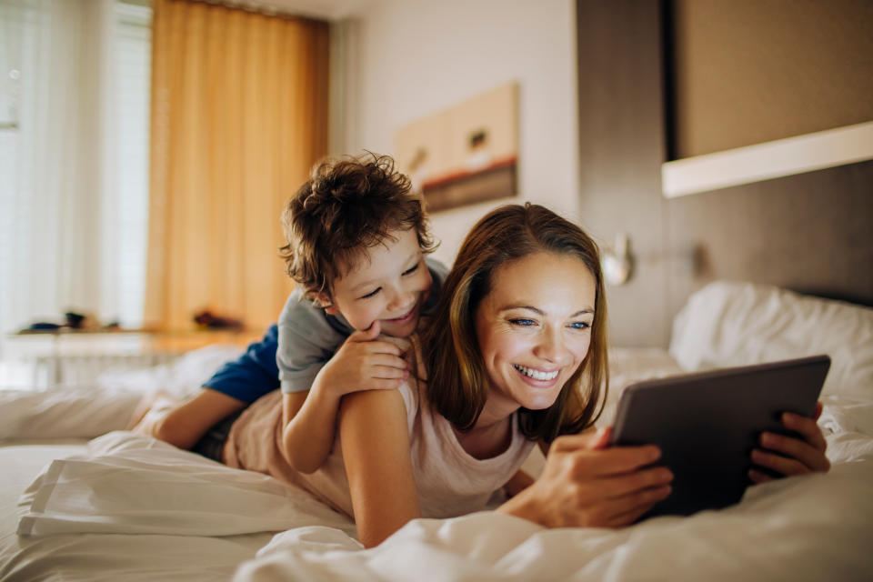 Close up photo of a mother and son using a digital tablet