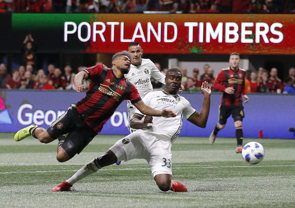 Atlanta United forward Josef Martinez (7) and Portland Timbers defender Larrys Mabiala (33) fight for the ball during the first half of the MLS Cup championship soccer game, Saturday, Dec. 8, 2018, in Atlanta. (AP Photo/Todd Kirkland)