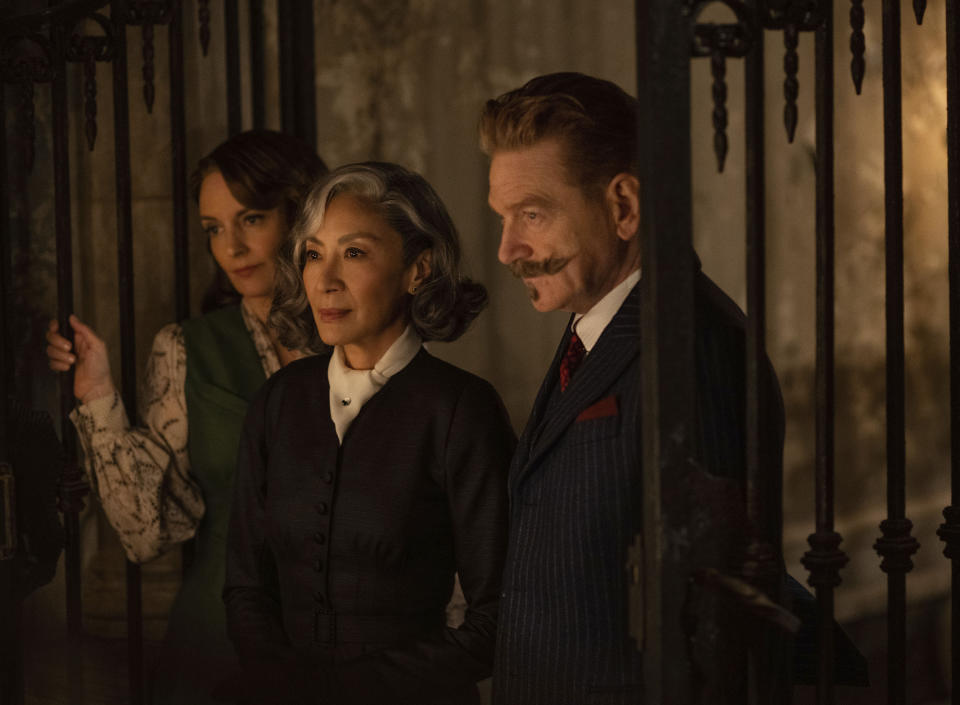 This image released by 20th Century Studios shows, from left,Tina Fey as Ariadne Oliver, Michelle Yeoh as Mrs. Reynolds, and Kenneth Branagh as Hercule Poirot in a scene from "A Haunting in Venice." (20th Century Studios via AP)