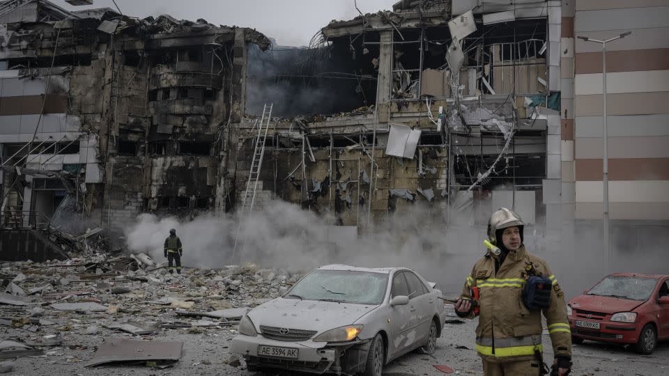 Officials work around destruction after Russian airstrikes killed 6 and injured around 28 people including a baby and severely damaged vehicles, a shopping mall and a maternity hospital according to statements of Governor of Dnipropetrovsk Serhiy Lysak in Dnipro, Ukraine on December 29, 2023. - Ozge Elif Kizil/Anadolu/Getty Images