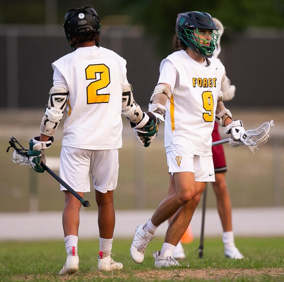 Forest Wildcats midfielder Dallas Eason (2) and Forest Wildcats attack Samuel Martin (9) celebrates a goal together in the first half. The Forest High School Wildcats hosted the Chiles Timberwolves at Forest High School in Ocala, FL on Wednesday, April 5, 2023. Forest led 9-2 at the half. [Doug Engle/Ocala Star Banner]