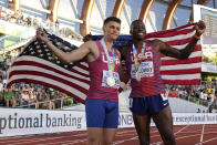 Gold medalist Grant Holloway, of the United States, right, poses with silver medalist Trey Cunningham, of the United States, after a final in the men's 110-meter hurdles the at the World Athletics Championships on Sunday, July 17, 2022, in Eugene, Ore. (AP Photo/Charlie Riedel)