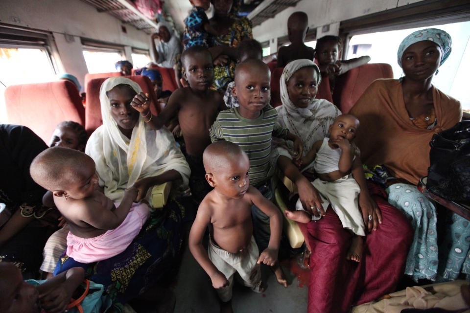 In this Photo taken, Friday, March . 8, 2013, Passengers ride aboard an Ooni of Ife train to Kano, Nigeria. Nigeria reopened its train line to the north Dec. 21, marking the end of a $166 million project to rebuild portions of the abandoned line washed out years earlier. The state-owned China Civil Engineering Construction Corp. rebuilt the southern portion of the line, while a Nigerian company handled the rest. The rebirth of the lines constitutes a major economic relief to the poor who want to travel in a country where most earn less than $1 a day. Airline tickets remain out of the reach of many and journeys over the nation's crumbling road network can be dangerous. The cheapest train ticket available costs only $13. ( AP Photo/Sunday Alamba)