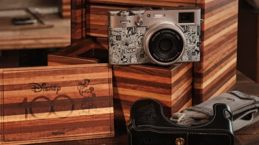 Disney-themed Fujifilm X100V camera and all its accessories on a wooden table