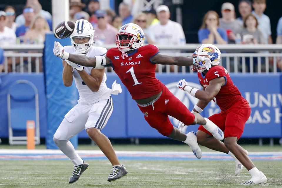 Kansas safety Kenny Logan Jr. (1) reaches for but is unable to grab a pass meant for BYU wide receiver Keanu Hill, left, as Kansas safety O.J. Burroughs (5) also defends during an NCAA football game on Saturday, Sept. 23, 2023, in Lawrence, Kan. | Colin E. Braley, Associated Press