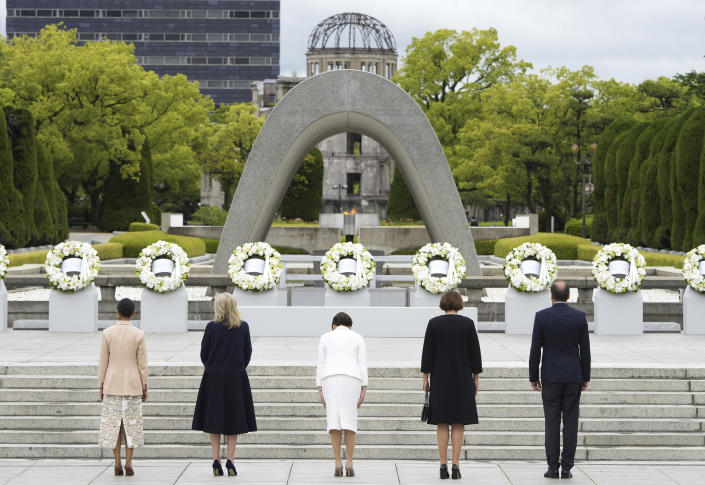 From left to right, wife of British Prime Minister Rishi Sunak, Akshata Murty, U.S. first lady Jill Biden, Japan's first lady Yuko Kishida, wife of German Chancellor Olaf Scholz, Britta Ernst, husband of European Commission President Ursula von der Leyen, Heiko von der Leyen, attend the flower wreath laying ceremony at the Cenotaph for Atomic Bomb Victims in the Peace Memorial Park as part of the G7 Summit in Hiroshima, western Japan Friday, May 19, 2023. (Franck Robichon/Pool Photo via AP)