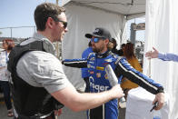 Ricky Stenhouse Jr., right, goes through a security checkpoint before the drivers meeting for the NASCAR Daytona 500 auto race at Daytona International Speedway, Sunday, Feb. 16, 2020, in Daytona Beach, Fla. Extra security measures were taken at the speedway because of the visit of President Donald Trump. (AP Photo/Reinhold Matay)