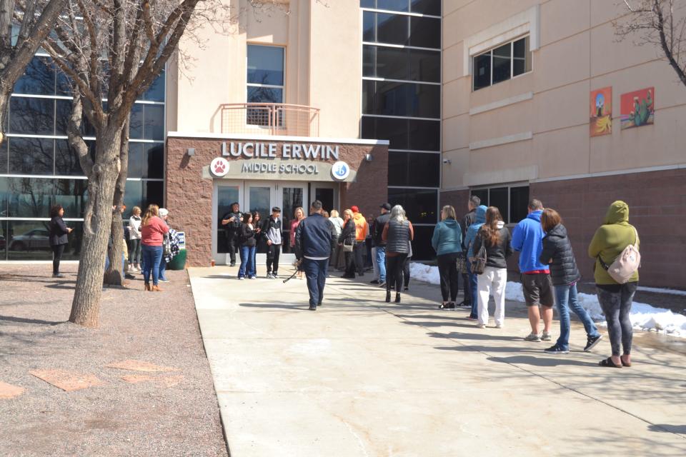 Parents line up outside of Lucile Erwin Middle School in Loveland to pick up their children Wednesday after learning that the school was placed on "secure perimeter" status because of a safety concern.