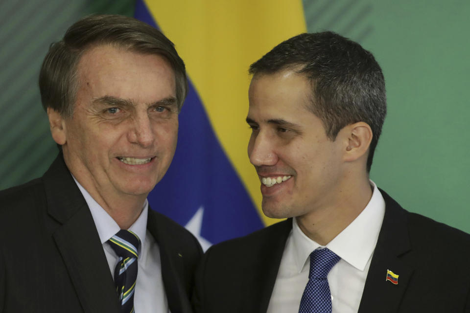 Brazil's President Jair Bolsonaro, left, and Venezuela's self-proclaimed interim president Juan Guaido smile during a joint statement in Brasilia, Brazil, Thursday, Feb.28, 2019. Guaido met Bolsonaro, who recognizes Guaido and has taken a hard line against Venezuelan President Nicolas Maduro. (AP Photo/Lucio Tavora)