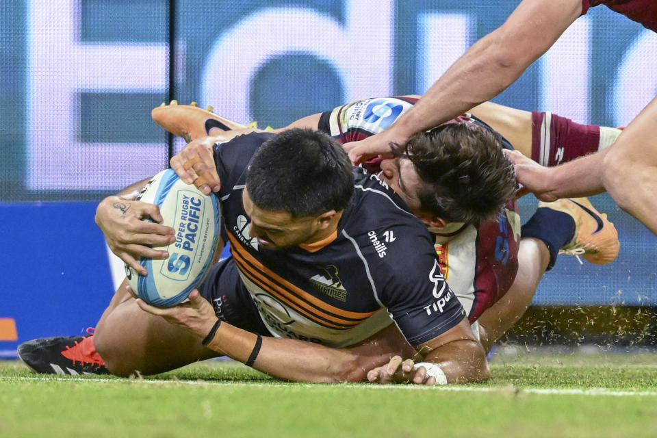 Tom Wright of the Brumbies scores a try during the Super Rugby match between the Queensland Reds and the Brumbies in Brisbane, Australia, Saturday, March 30, 2024. (Darren EnglandAAP via AP)