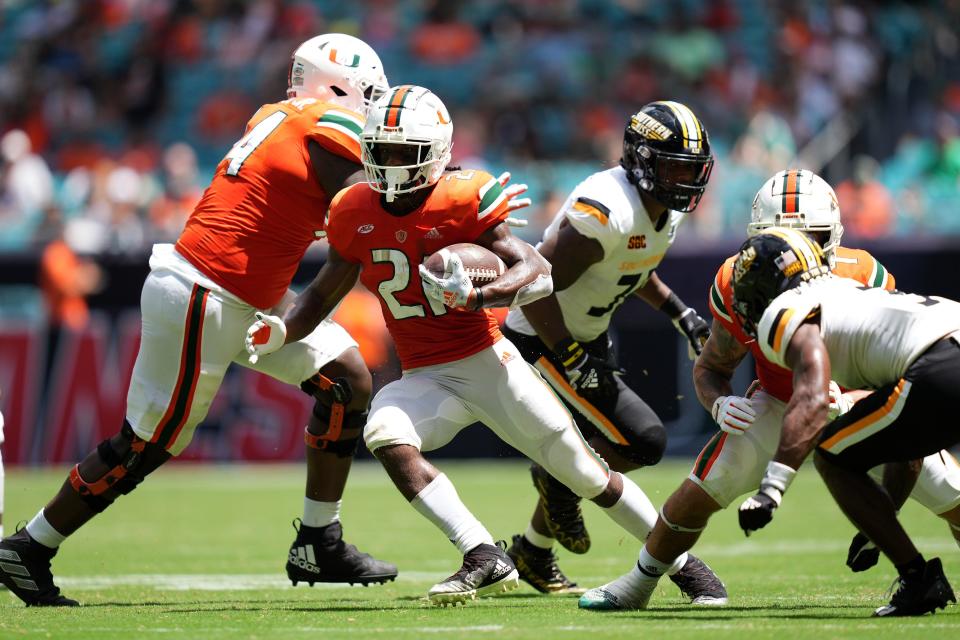 Miami running back Henry Parrish Jr. (21) runs the ball against Southern Mississippi during the second half at Hard Rock Stadium.