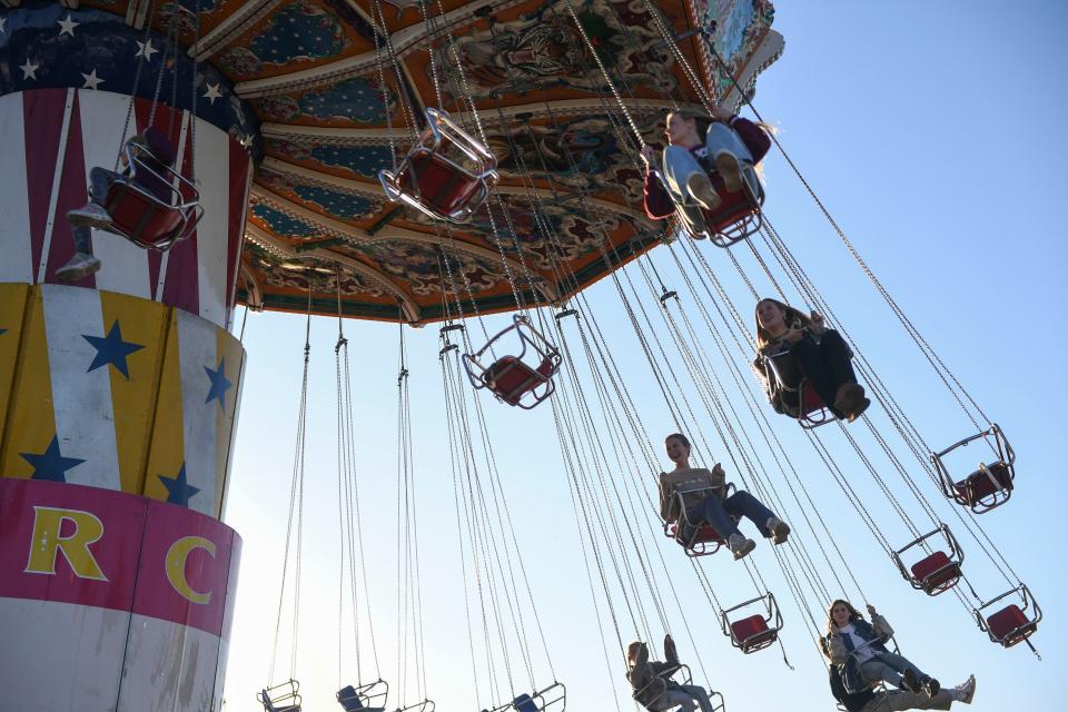 FILE - Fair-goers ride giant swings during opening night at the Columbia County Fair at the county fairgrounds on Thursday, Nov. 2, 2023. The spring fair is on now through April 28.