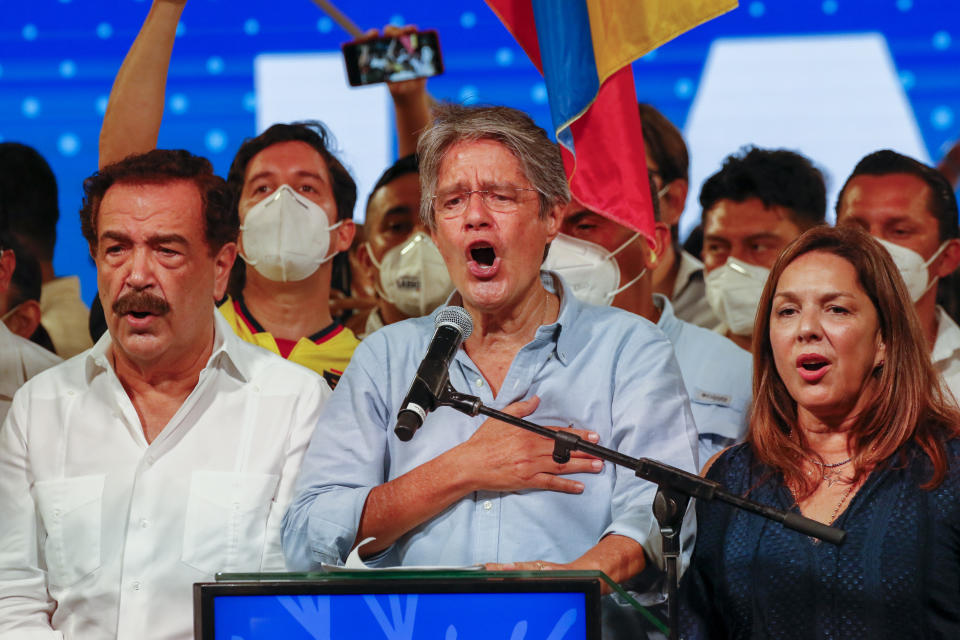 Guillermo Lasso, presidential candidate of Creating Opportunities party, CREO, center, celebrates with his wife María de Lourdes Alcívar, right, after a presidential runoff election at his campaign headquarters in Guayaquil, Ecuador, Sunday, April 11, 2021. With most of the votes counted Lasso, a former banker, had a lead over economist Andres Arauz, a protege of former President Rafael Correa.(AP Photo/Angel Dejesus)