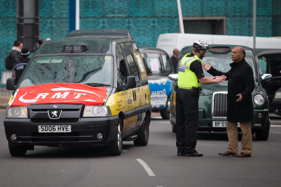 Police officers direct traffic as taxis engage in a 'go slow' protest on the Holloway Circus roundabout in Birmingham City Centre as drivers protest over the city councils plans for a new clean air zone in Birmingham.