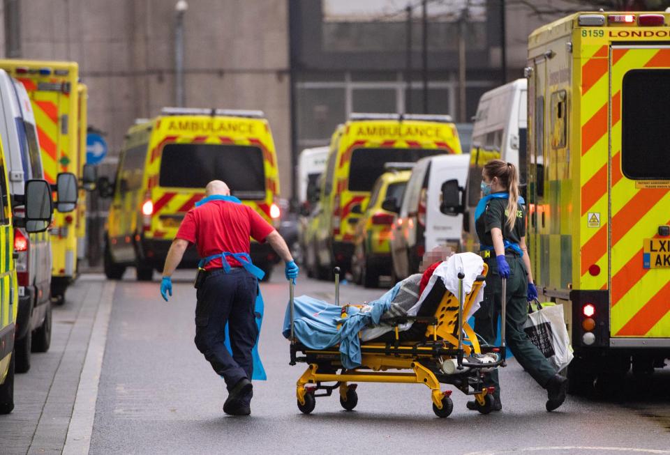 Paramedics unloading a patient from an ambulance outside the Royal London Hospital (PA Wire)