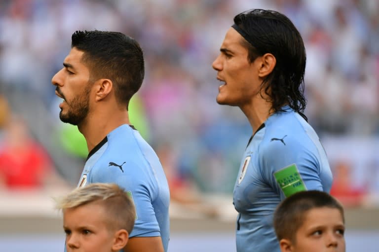 Luis Suarez (left) and Edinson Cavani both scored as Uruguay beat Russia 3-0 to top World Cup Group A