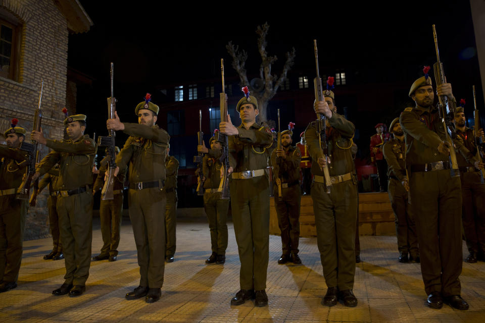 Indian policemen pay homage during the wreath-laying ceremony of their colleague in Srinagar, Indian controlled Kashmir, Monday, Feb. 18, 2019. Tensions escalated in the aftermath of a suicide attack in disputed Kashmir, with nine people killed Monday in a gunbattle that broke out as Indian soldiers scoured the area for militants.(AP Photo/ Dar Yasin)