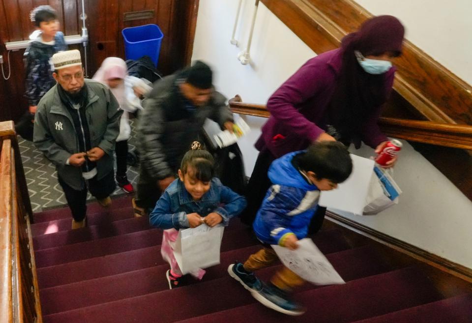 Families make their way upstairs to view Sesame Street in the Rohingya language with two 6-year-old Rohingya twin characters named Aziz and Noor Saturday, Oct. 15, 2022, at the Burmese Rohingya Community of Wisconsin in Milwaukee.