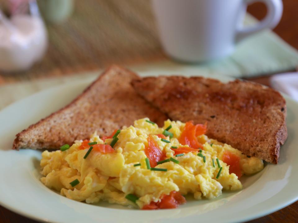 scrambled eggs with toast on a plate