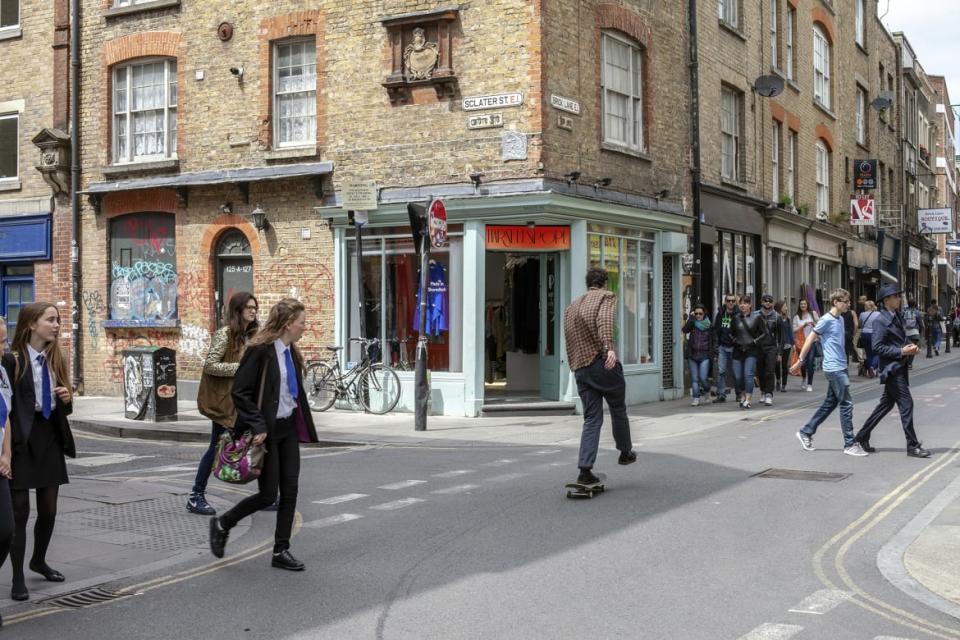 <div class="inline-image__caption"><p>People walk through Brick Lane in London.</p></div> <div class="inline-image__credit">Stuart Freedman/In Pictures via Getty </div>