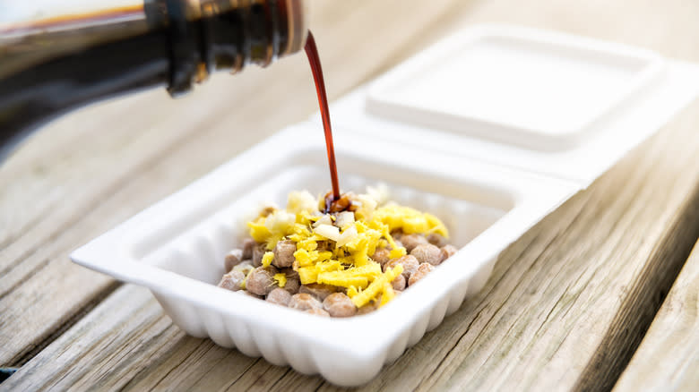 soy sauce poured over natto