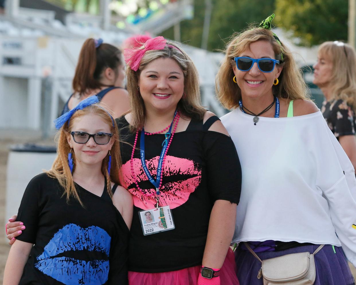 From left, Pason Fox, Audrey Wegner and Amy Francoeur were decked out in 1980s fashion during Thursday's “Bodacious Moves and Big Hair at the Fair: Lenawee’s Premier ’80s Dance Party” at the grandstand. Fox won first place in the best dressed female category. Francoeur won second place.