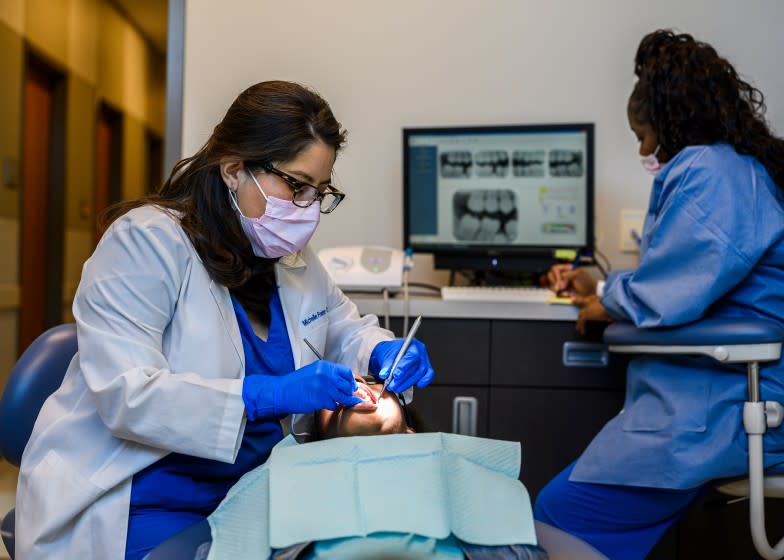 West Memphis, Ark. - Dentist Michelle Freire-Troxel, from left, cleans the teeth of Amari Harris, while Dental Assistant, Chyna Miller, takes notes at the East Arkansas Family Health Center in West Memphis, Ark. on Friday March 6, 2019. CREDIT: William DeShazer