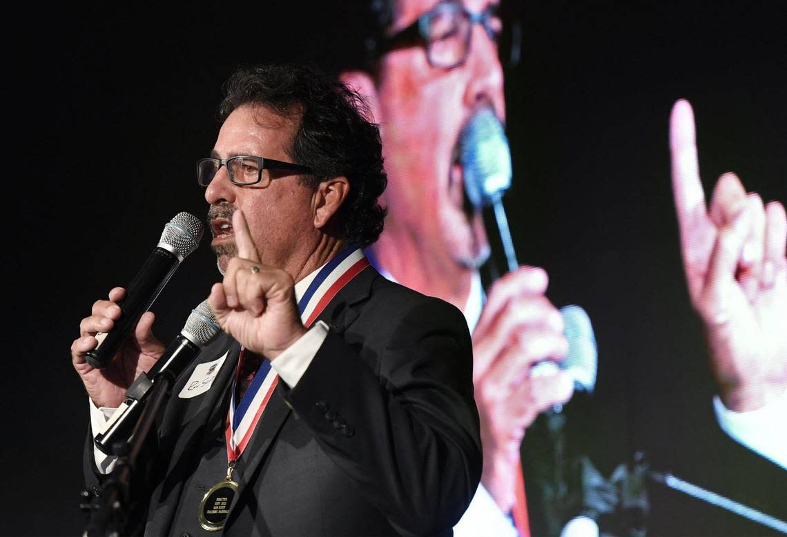 2022 inductee Fresno City College baseball coach Ron Scott jokingly points out he has a new suit for the event as he thanks his supporters at the 63rd Annual Fresno County Athletic Hall of Fame Enshrinement Night Wednesday, Sept. 21, 2022 in Fresno. The event was also the grand opening for the Athletic Hall of Fame’s new location inside the Save Mart Center at Fresno State. ERIC PAUL ZAMORA/ezamora@fresnobee.com